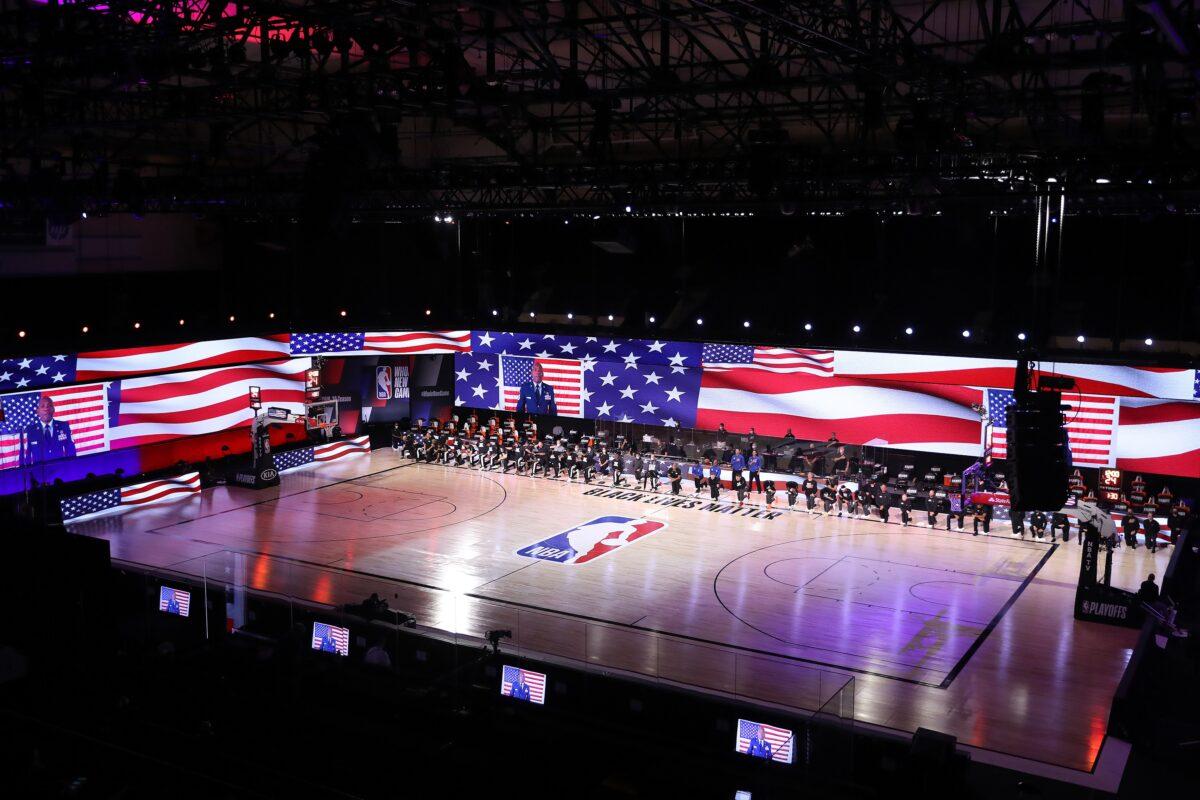 The Los Angeles Clippers and Denver Nuggets kneel during the national anthem before their game at the ESPN Wide World Of Sports Complex in Lake Buena Vista, Fla., on Sept. 11, 2020. (Michael Reaves/Getty Images)