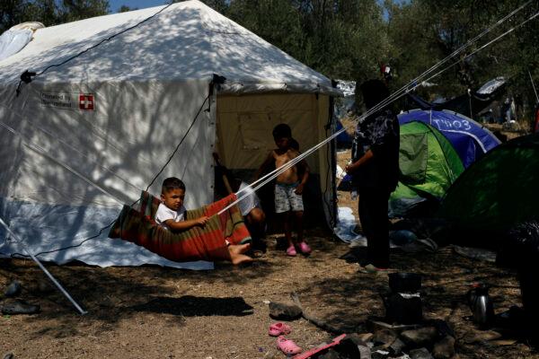 A child plays on a makeshift swing near the burned Moria camp on island of Lesbos, Greece, on Sept. 13, 2020. (Petros Giannakouris/ AP Photo)