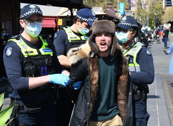  Police detain an anti-lockdown protester at Melbourne's Queen Victoria Market during a rally on Sept. 13, 2020. (William West/AFP via Getty Images)