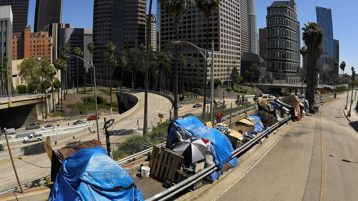 A homeless encampment on Beaudry Avenue as traffic moves along Interstate 110 in downtown Los Angeles on May 21, 2020. (Mark J. Terrill/AP)
