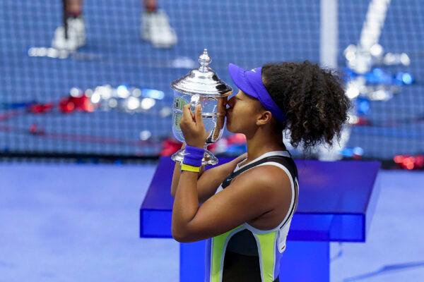 Naomi Osaka, of Japan, holds up the championship trophy after defeating Victoria Azarenka, of Belarus, in the women's singles final of the U.S. Open tennis championships in New York on Sept. 12, 2020. (AP Photo/Seth Wenig)