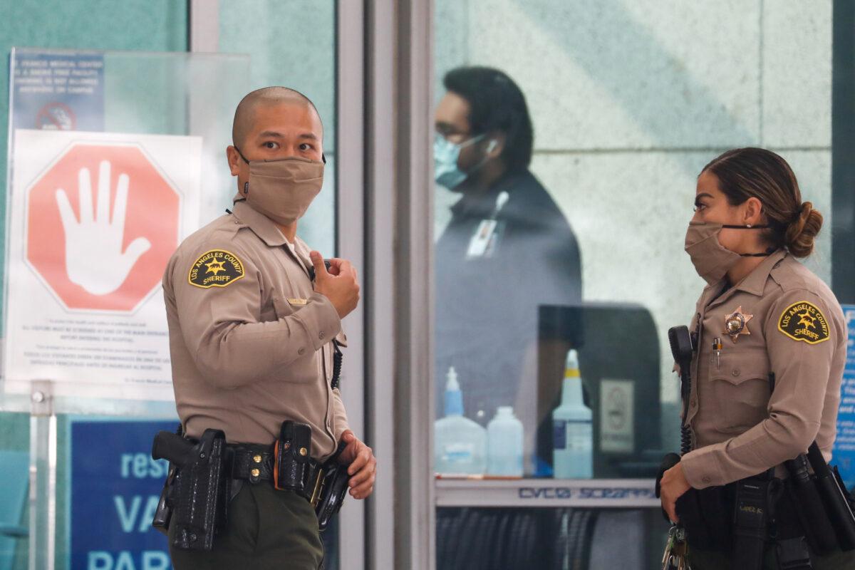 Los Angeles County Sheriffs Department (LASD) deputies stand outside St. Francis Medical Center hospital following the ambush shooting of two deputies in Compton, in Lynwood, Calif., on Sept. 13, 2020. (Patrick T. Fallon/Reuters)