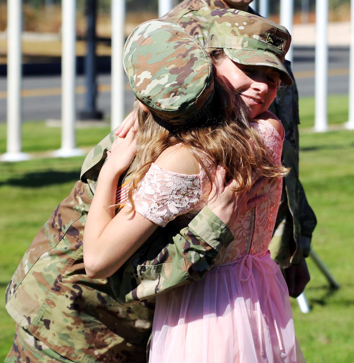 Col. Kristin Derda hugs her daughter, Emilia, after being promoted at Camp Murray, Washington, on Sept. 3, 2020 (<a href="https://www.dvidshub.net/image/6338849/joint-promotion-ceremony-special-washington-guard-family">Joseph Siemandel</a>/U.S. National Guard)