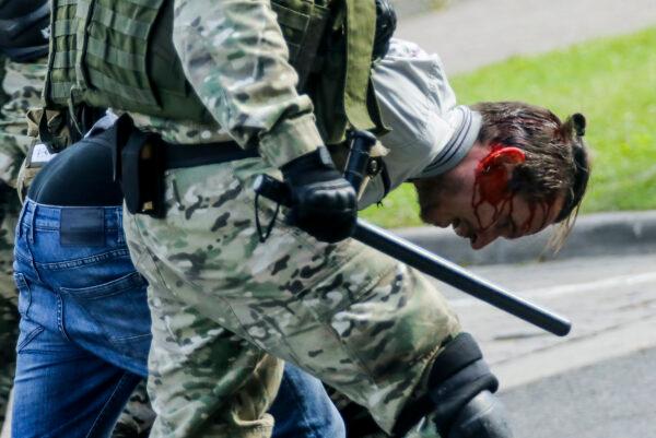 Riot police officers detain a protester during an opposition rally in Minsk, on Sept. 13, 2020. (AP Photo)