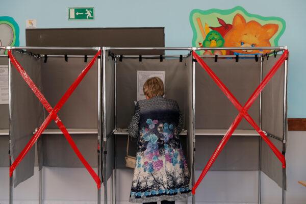 A woman checks her ballot in a voting booth during local elections in the Siberian city of Tomsk, Russia, on Sept. 12, 2020. (Maxim Shemetov/Reuters)