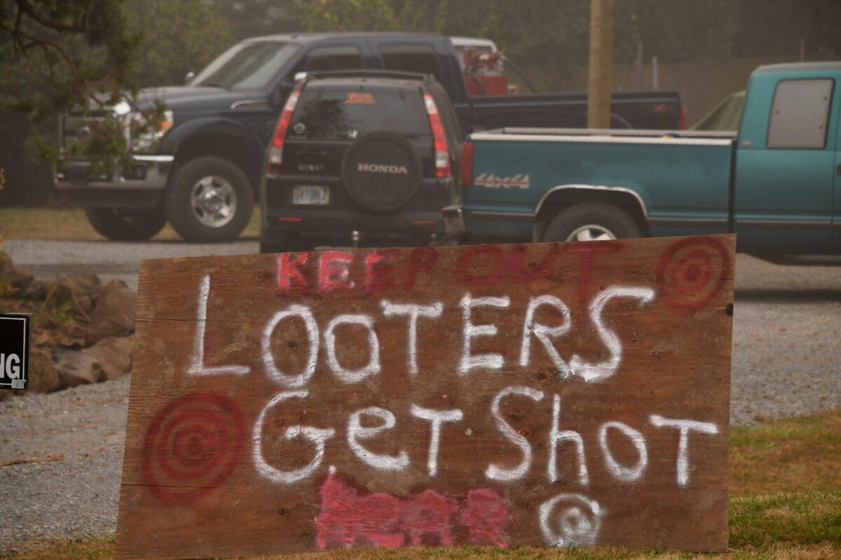 A sign reads "Looters Get Shot" outside a residence in Molalla, Ore., on Sept. 13, 2020. (Robyn Beck/AFP via Getty Images)