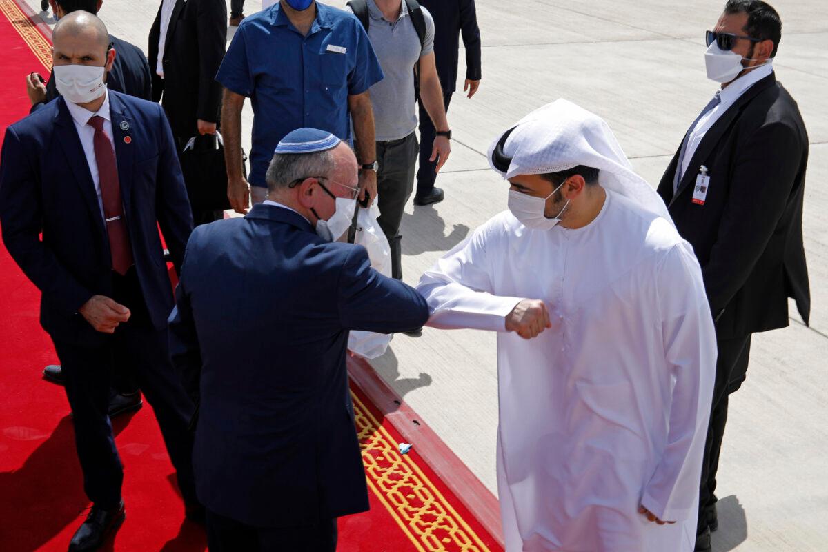 Israeli National Security Adviser Meir Ben-Shabbat (center left) elbow bumps with an Emirati official as he leaves Abu Dhabi, United Arab Emirates, on Sept. 1, 2020. (Nir Elias/Pool via AP)