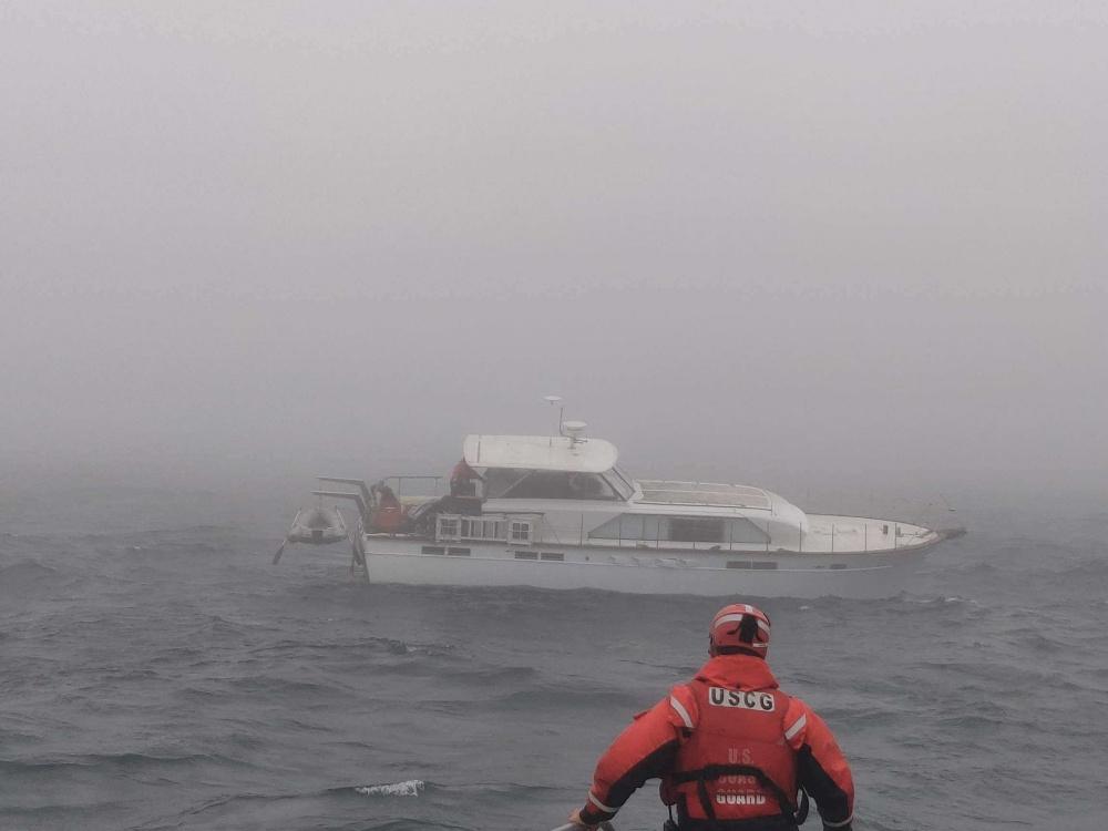 A Coast Guard Station Humboldt Bay crew member looks out at the pleasure craft Wooden Mistress, 28 miles south of Eureka, Calif., Sept. 12, 2020.  (<a href="https://content.govdelivery.com/accounts/USDHSCG/bulletins/2a06214">U.S. Coast Guard</a>)