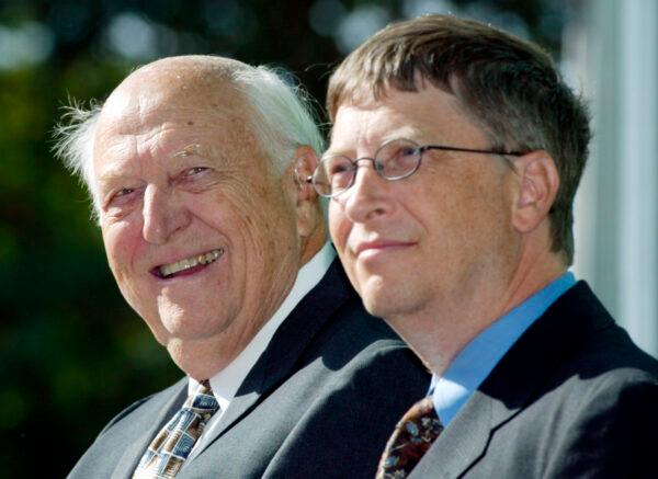 William H. Gates Sr. (L) smiles while sitting next to his son, Bill Gates Jr., during the dedication and grand opening of the William H. Gates Hall, new home of the University of Washington School of Law in Seattle, Wash., on Sept. 12, 2003. (John Froschauer/AP Photo)