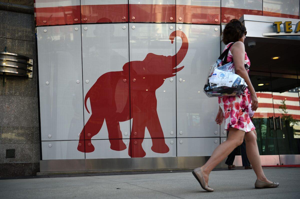 A woman walks past the elephant logo of the Republican Party on the first day of the Republican National Convention in Cleveland, Ohio, on July 18, 2016. (Dominick Reuter/AFP via Getty Images)