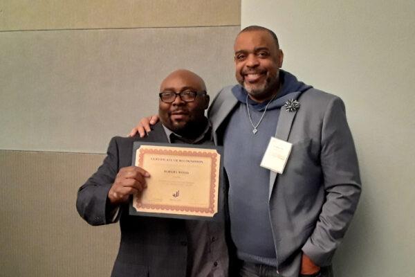 Robert Wood (L) stands with the dean of student affairs at Cal State University at a conference on incarceration where Wood was a speaker on one of the panels. (Courtesy of Robert Wood)