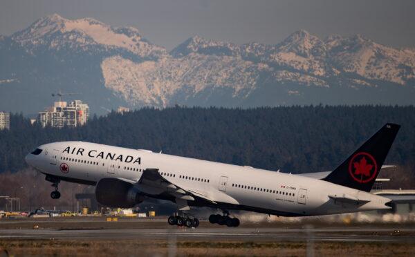 An Air Canada flight departing for Toronto takes off at Vancouver International Airport, in Richmond, Canada on March 20, 2020. (Darryl Dyck/The Canadian Press)