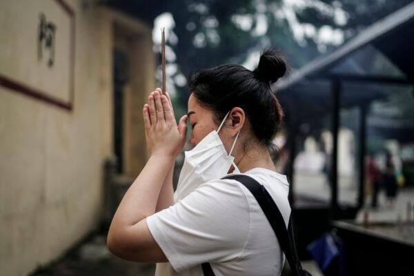 A woman worships at the Guiyuan temple in Wuhan, in Hubei Province on Sept. 16, 2020. (Getty Images)