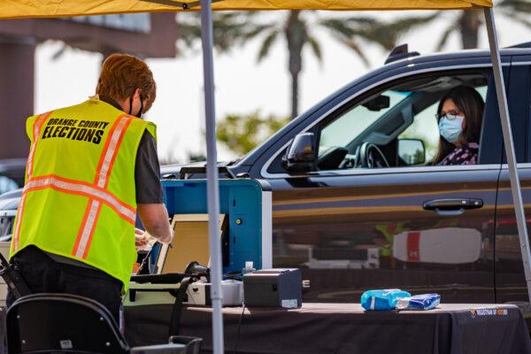 An Orange County election worker demonstrates the drive-thru voting process outside the Honda Center in Anaheim, Calif., on Sept. 16, 2020. (John Fredricks/The Epoch Times)