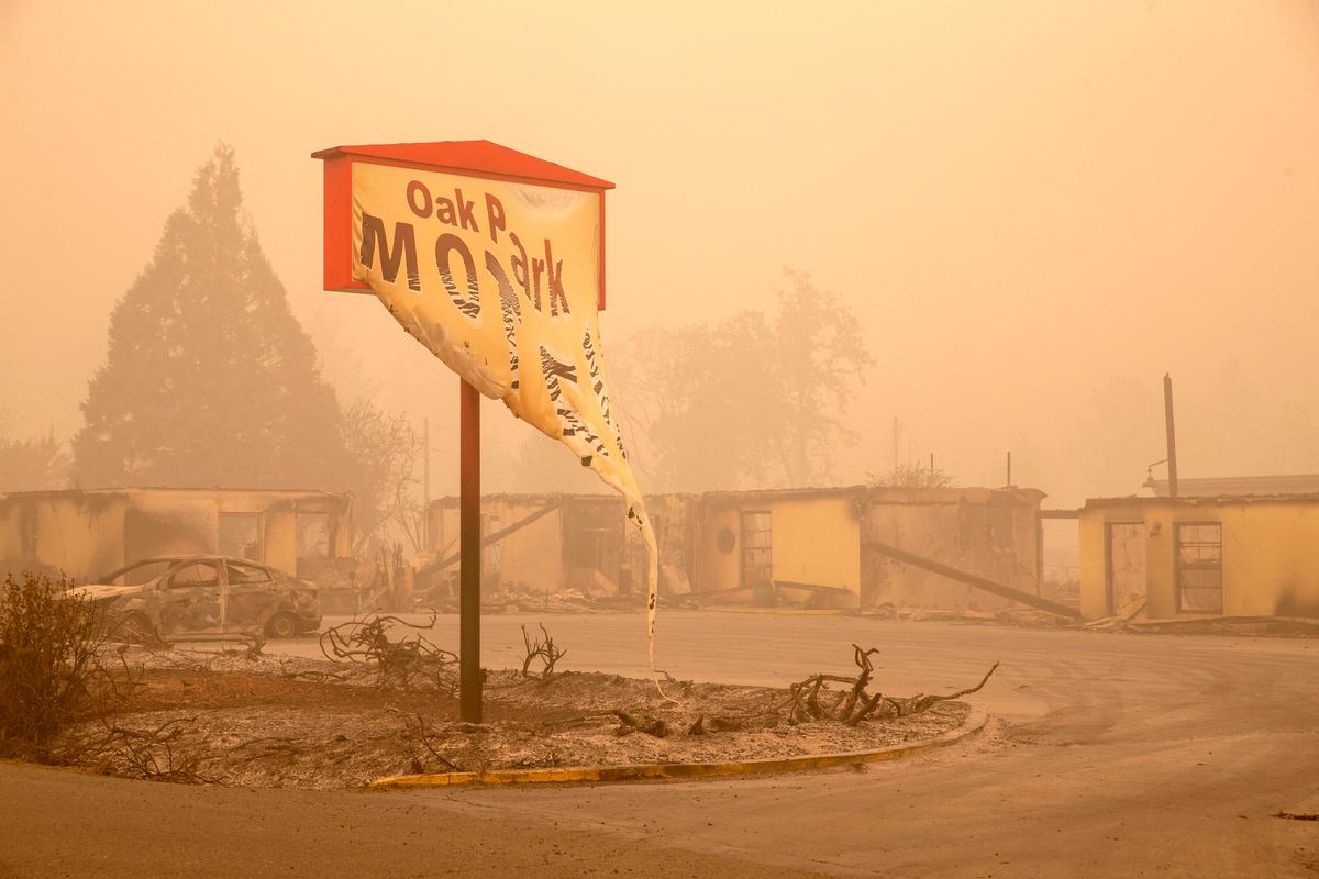 The melted sign of the Oak Park Motel destroyed by the flames of the Beachie Creek Fire is seen in Gates, east of Salem, Ore., on Sept. 13, 2020. The wildfire caused the evacuation of 40,000 residents, killing four people, and five are still missing (ROB SCHUMACHER/POOL/AFP via Getty Images)