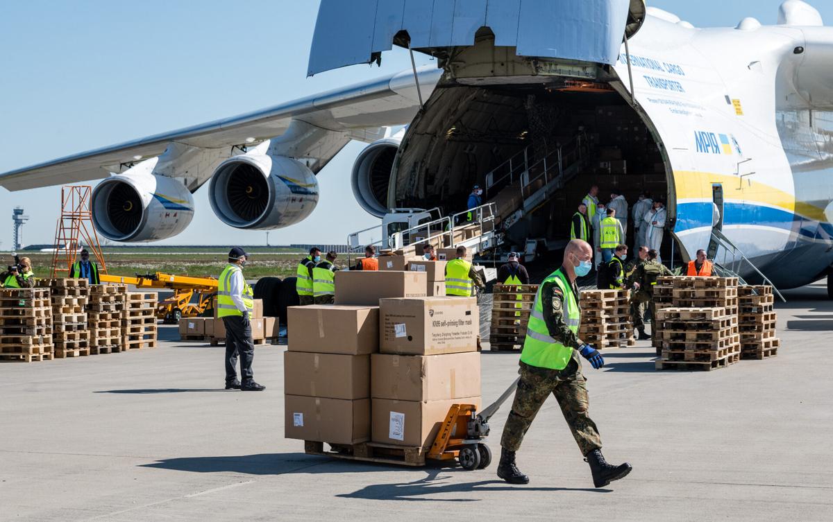 Soldiers of the Bundeswehr, the German armed forces, unload a shipment of 10 million protective face masks and other protective medical gear that had arrived on a cargo plane from China during the COVID-19 crisis at Leipzig/Halle Airport in Schkeuditz, Germany, on April 27, 2020. (Jens Schlueter/Getty Images)