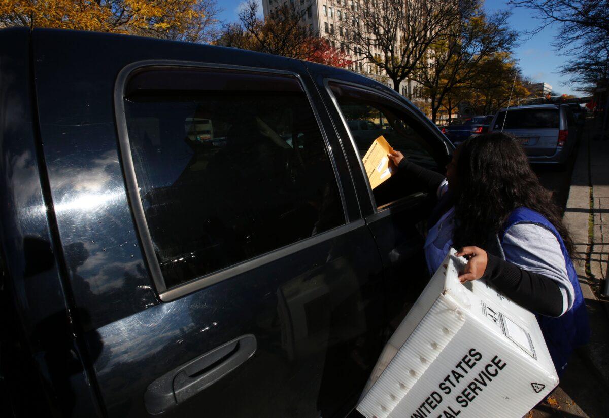 LaSean Madden collects absentee ballots outside the Detroit Elections Department in Detroit, Mich., on Nov. 4, 2016. (Jeff Kowalsky/AFP via Getty Images)