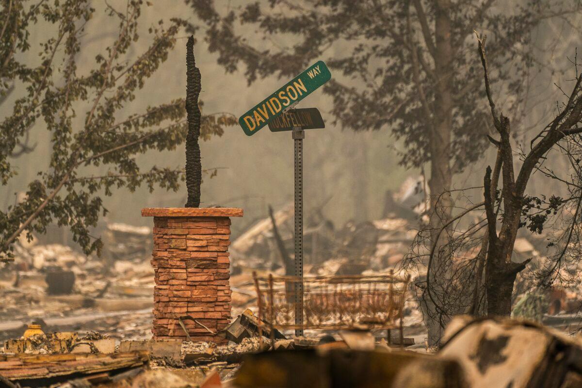 A burnt street sign dangles on a pole in a neighborhood destroyed by wildfire in Talent, Ore., Sept. 13, 2020. (David Ryder/Getty Images)