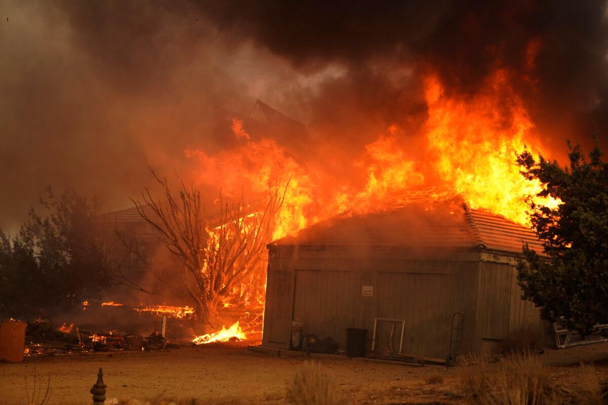 A home burns along Cima Mesa Rd. as the Bobcat Fire advances, in Juniper Hills, Calif., on Sept. 18, 2020. (Marcio Jose Sanchez/AP Photo)