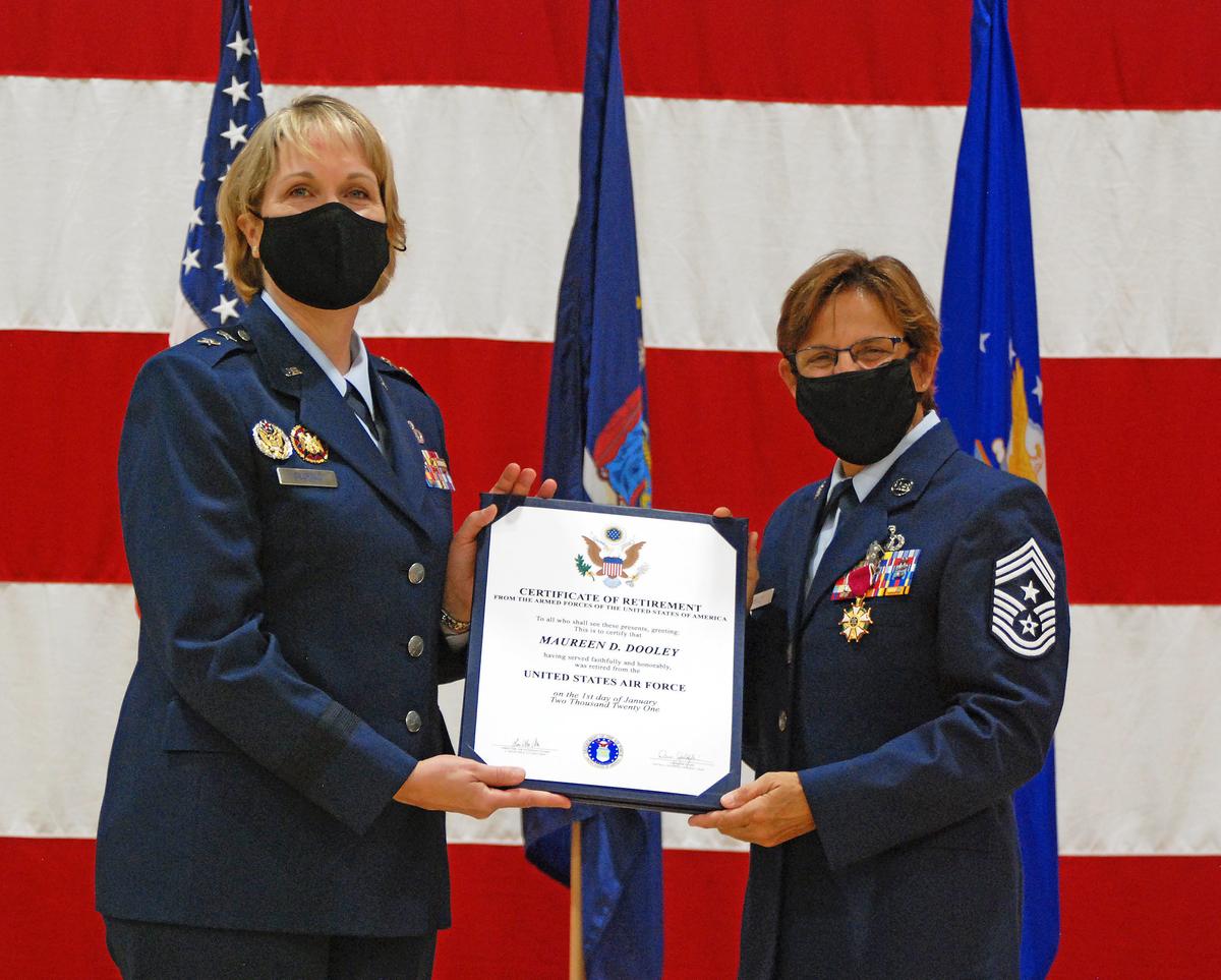 Major General Dawn Deskins, deputy director of the Air National Guard (L), presents Dooley with her retirement certificate in Latham, New York, on Sept. 18, 2020 (<a href="https://www.dvidshub.net/image/6355825/command-chief-master-sgt-maureen-dooley-retirement">William Albrecht</a>/New York State Division of Military and Naval Affairs)