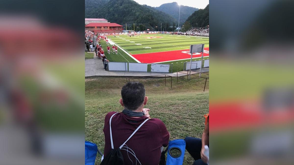 Sullivan watches the game from a hillside next to Haywood Field in Belfry, Kentucky. (Courtesy of Jerree Humphrey)
