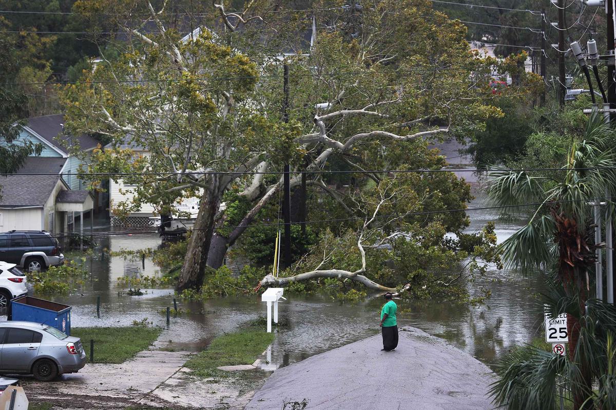A person looks at a flooded neighborhood as Hurricane Sally passes through the area on September 16, 2020 in Pensacola, Florida. (Joe Raedle/Getty Images)