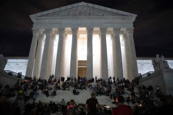 People gather to mourn the passing of Supreme Court Justice Ruth Bader Ginsburg at the steps in front of the Supreme Court in Washington, on Sept. 18, 2020. (Tasos Katopodis/Getty Images)