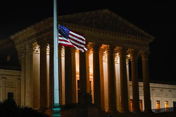 The American flag blows in the wind after it was lowered to half-staff in Washington after the Supreme Court announced that Justice Ruth Bader Ginsburg had died, on Sept. 18, 2020. (AP Photo/Alex Brandon)
