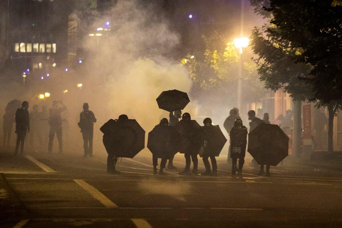 Tear gas fills the air during the dispersal of an unlawful assembly at the Immigration and Customs Enforcement detention center in Portland, Ore., on Sept. 18, 2020. (Paula Bronstein/AP Photo)
