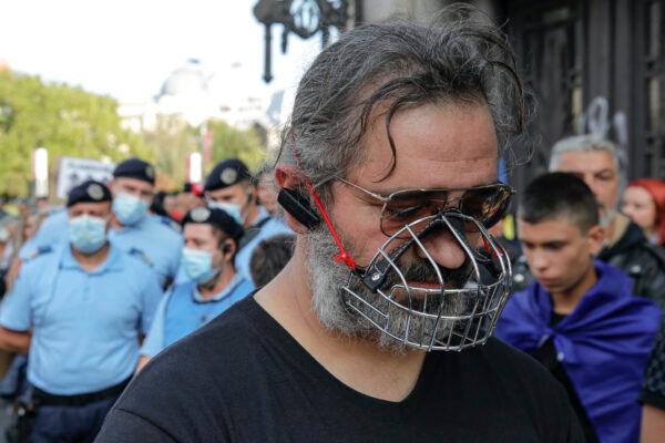A man wears a muzzle during a protest in Bucharest, on Sept. 19, 2020. (Vadim Ghirda/AP Photo)