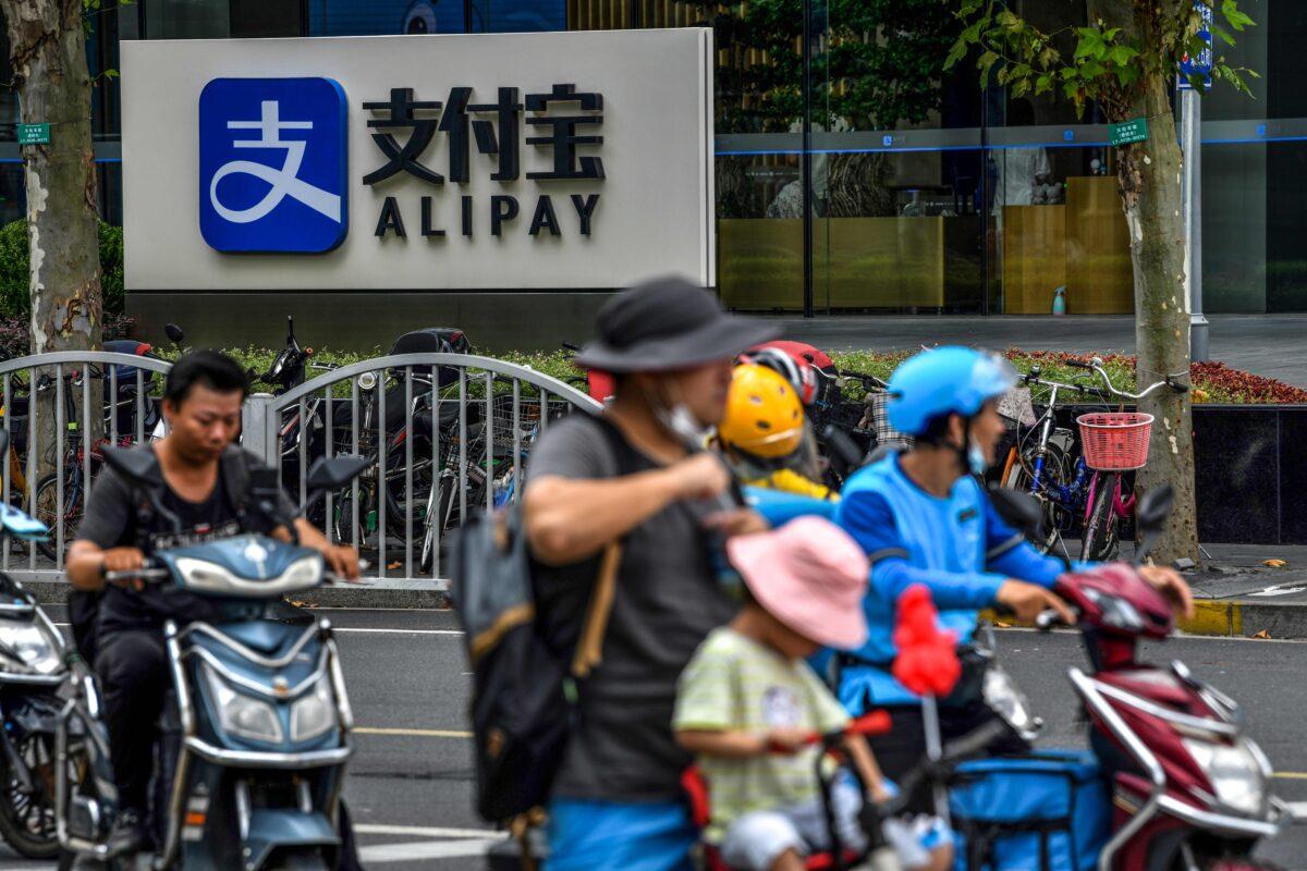 Motorists drive past an Alipay logo next to the Shanghai office building of Ant Group in Shanghai, on Aug. 28, 2020. (Hector Retamal/AFP via Getty Images)