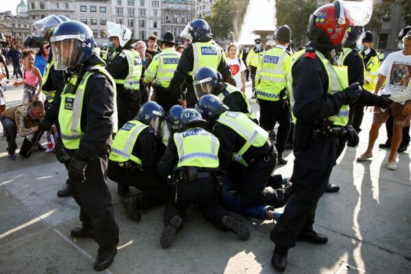 A person is detained during a demonstration in Trafalgar Square against the lockdown imposed by the government, in London, on Sept. 19, 2020. (Henry Nicholls/Reuters)