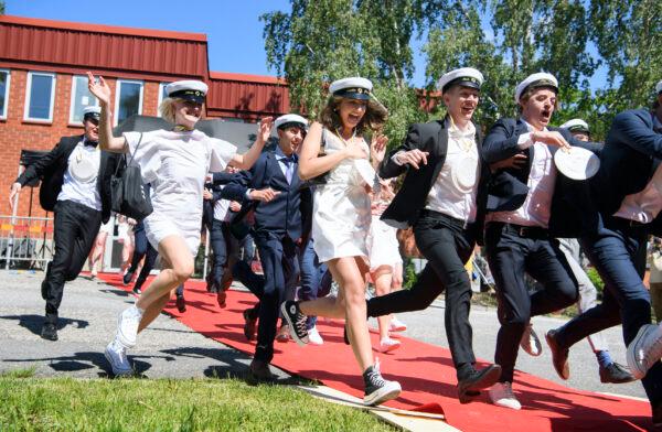 Students run celebrating their high school graduation at Nacka Gymnasium in Stockholm, on June 3, 2020. (Jessica Gow/TT via AP Photo)