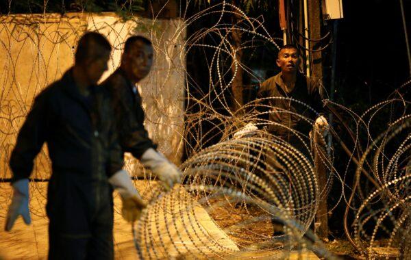Security guards set up barbed wire to block the Government House during a mass rally to call for the ouster of Prime Minister Prayuth Chan-ocha's government and reforms in the monarchy, in Bangkok, Thailand, on Sept. 20, 2020. (Soe Zeya Tun/Reuters)
