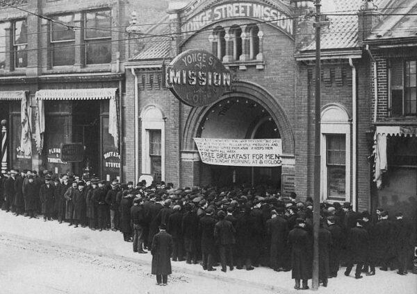People wait in the food line at the Yonge Street Mission in Toronto during the Great Depression in the 1930s. (Public Domain)