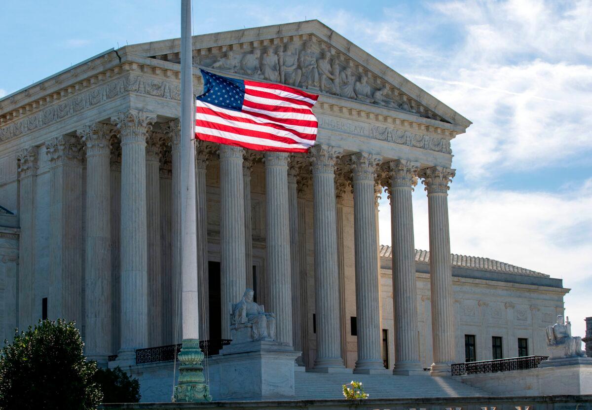 The US flag flies at half-staff outside of the US Supreme Court in memory of Justice Ruth Bader Ginsburg, in Washington on Sept. 19, 2020. (Jose Luis Magana/AFP via Getty Images)