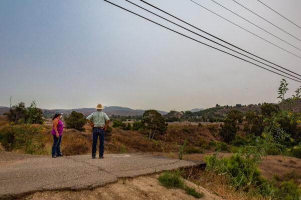Loral Maldonado and David Hillman, longtime residents of the Orange Park Acres neighborhood of Orange, Calif., look over a swath of land that’s part of a development proposal, on Sept. 10, 2020. (John Fredricks/The Epoch Times)