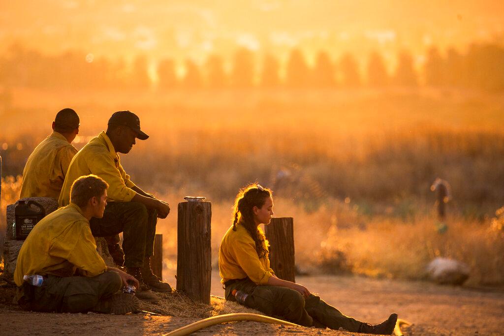 Firefighters rest during a wildfire in Yucaipa, Calif., Saturday, Sept. 5, 2020. (Ringo H.W. Chiu/AP Photo)