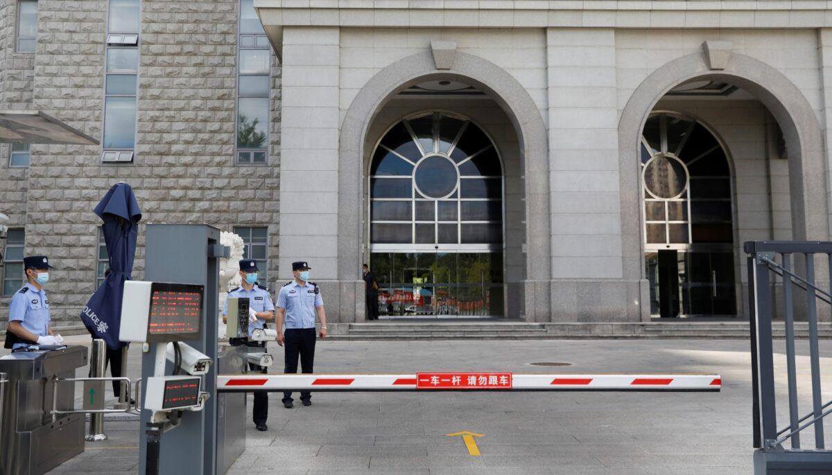 Police officers stand guard at an entrance to Beijing No. 2 Intermediate People's Court, where Huayuan Real Estate Group former chairman Ren Zhiqiang faces corruption trial, in Beijing, China, on Sept. 11, 2020. (Carlos Garcia Rawlins/File/Reuters)