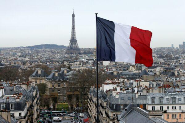 A city view shows the French flag above the skyline of the French capital as the Eiffel Tower and roof tops are seen in Paris on March 30, 2016. (Benoit Tessier/Reuters)