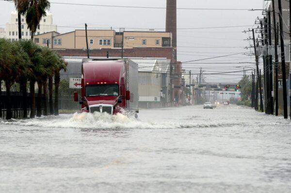 A truck drives through a flooded street in Galveston, Texas on Sept. 21, 2020. (Jennifer Reynolds/The Galveston County Daily News via AP)