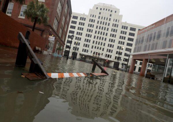 A barricade floats along flooded Strand Street near 25th Street in Galveston, Texas on Sept. 21, 2020. (Jennifer Reynolds/The Galveston County Daily News via AP)