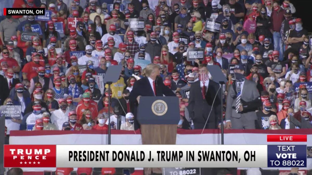 President Donald Trump speaks to Brady Williams and Jarad Bentley, seniors at Little Miami High School, on stage at a rally in Swanton, Ohio, on Sept. 21, 2020. (Donald J. Trump campaign / screengrab via YouTube)
