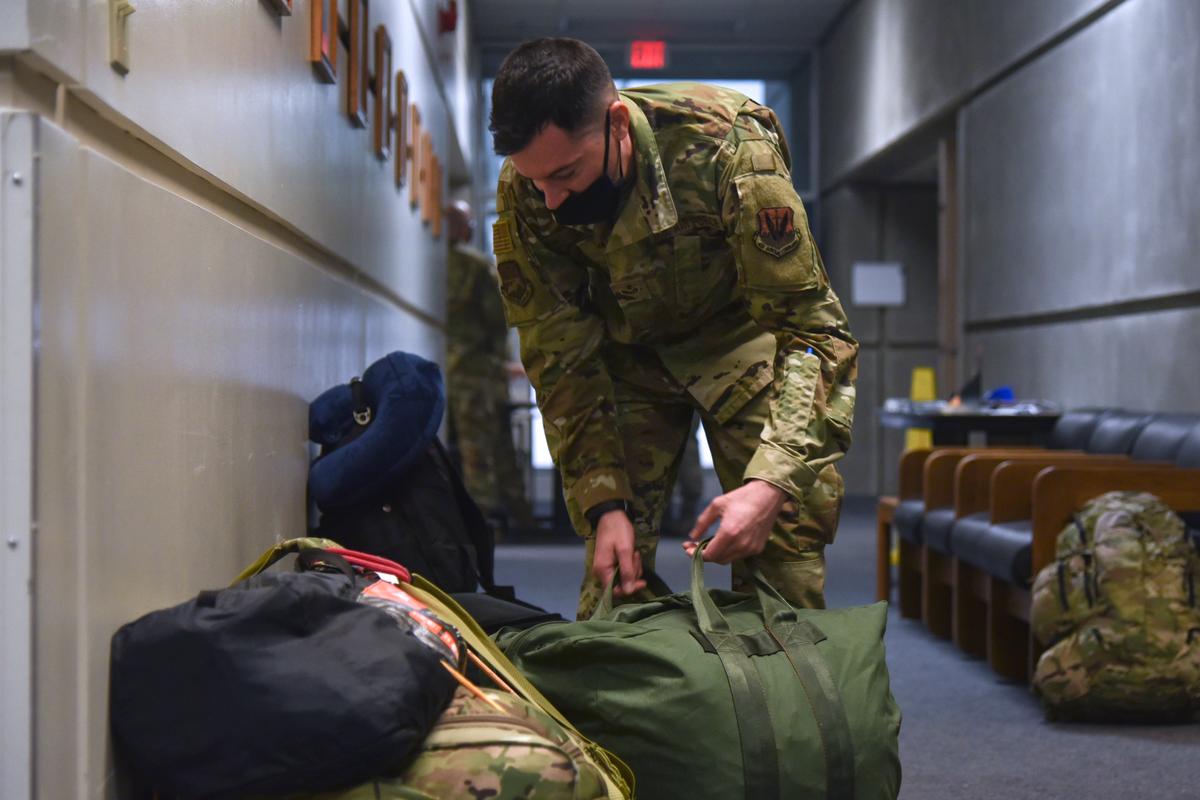 An Oregon Air National Guard member from the 142nd Wing packs his gear before leaving with a team of Airmen in support of Operation Plan Smokey at the Portland Air National Guard Base, Portland, Ore.,  on Sept. 13, 2020. (<a href="https://www.142fw.ang.af.mil/News/Photos/igphoto/2002496372/">Senior Airman Valerie R. Seelye</a>/U.S. Air National Guard)