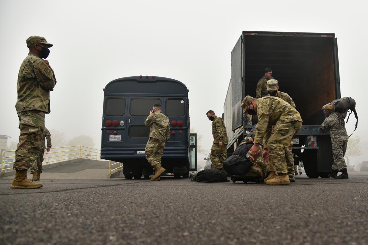 Oregon Air National Guard members from the 142nd Wing load their gear in a truck before leaving from the Portland Air National Guard Base. (<a href="https://www.142fw.ang.af.mil/News/Photos/igphoto/2002496373/">Senior Airman Valerie R. Seelye</a>/U.S. Air National Guard)
