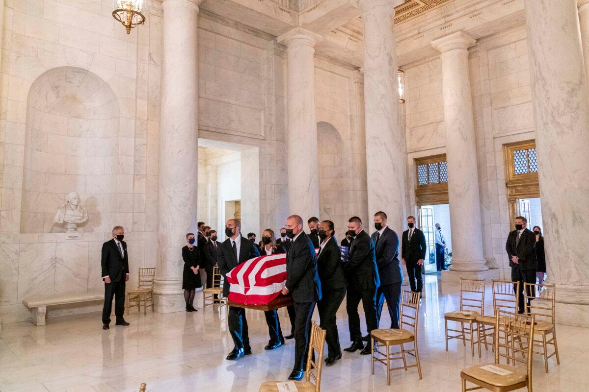 The flag-draped casket of Justice Ruth Bader Ginsburg, carried by Supreme Court police officers, arrives in the Great Hall at the Supreme Court in Washington, on Sept. 23, 2020. (Andrew Harnik/Pool/AP Photo)