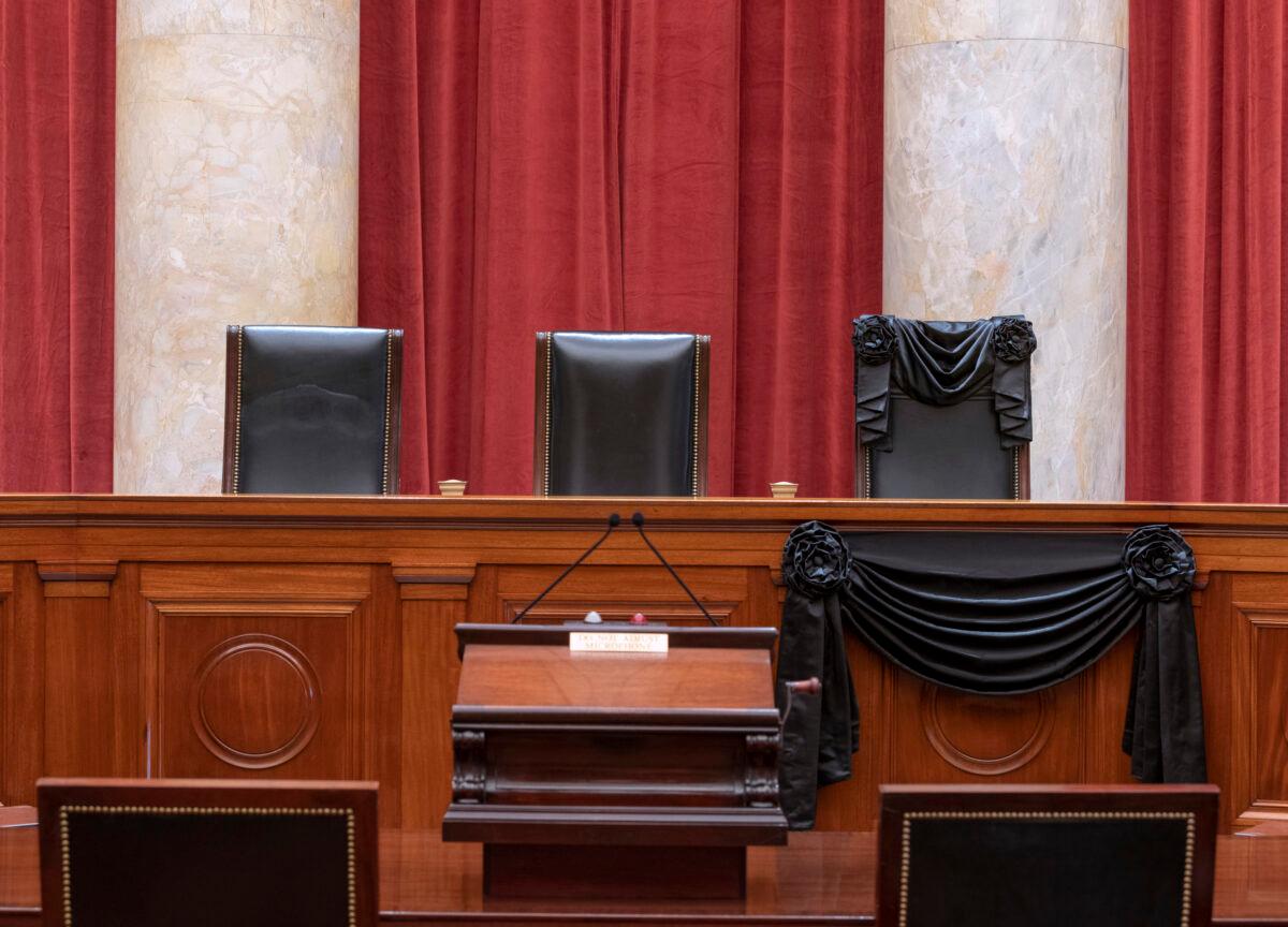 The bench and seat of Associate Justice Ruth Bader Ginsburg is draped in black cloth after her death, in Washington on Sept. 19, 2020. (Fred Schilling/Collection of the Supreme Court of the United States/Getty Images)