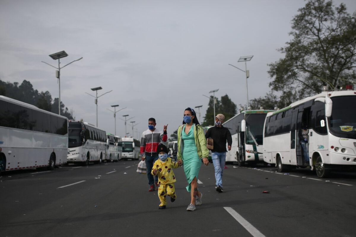 Venezuelan migrants participate in a protest against the blockade of buses that they hired to reach the Colombian-Venezuelan border, in Bogota, Colombia, on April 29, 2020. (Luisa Gonzalez/Reuters)