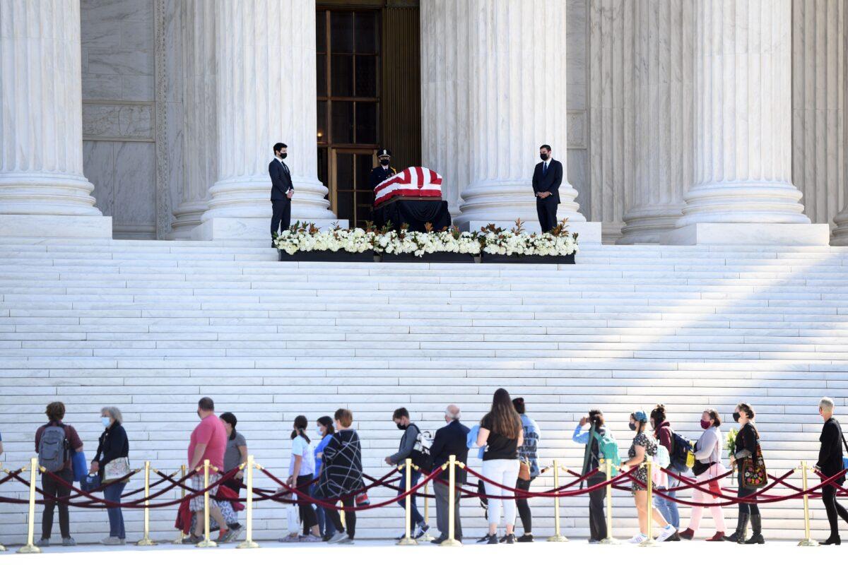 People pay respects as Justice Ruth Bader Ginsburg lies in repose in front of the Supreme Court in Washington on Sept. 23, 2020. (Saul Loeb/AFP via Getty Images)