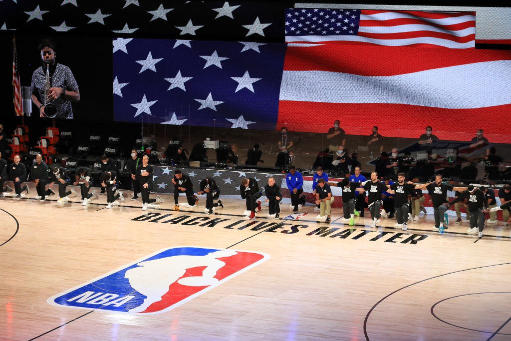 The Utah Jazz and the Denver Nuggets kneel during the national anthem during the NBA Playoffs at AdventHealth Arena at ESPN Wide World Of Sports Complex in Lake Buena Vista, Fla., on Sept. 1, 2020 (Mike Ehrmann/Getty Images)